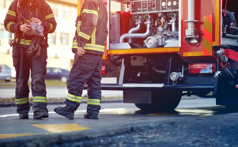 photo of two firefighters evaluating used fire engines for sale by Bradford Fire Apparatus