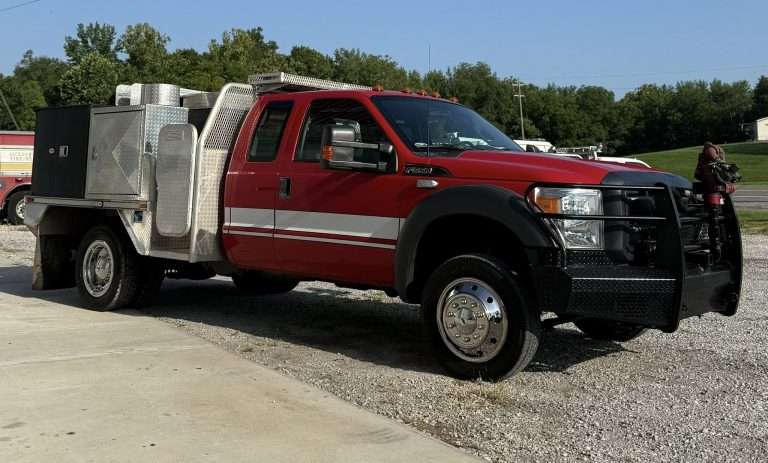 Used fire truck from one of many trusted fire truck manufacturers featuring a Ford chassis with utility body and front-mounted pump.